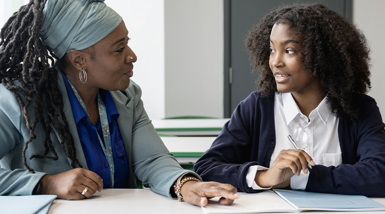 Teacher working closely with student