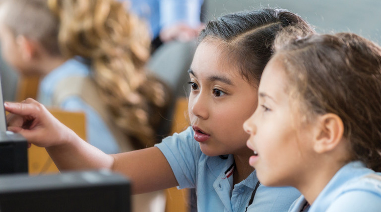 Students using devices in class